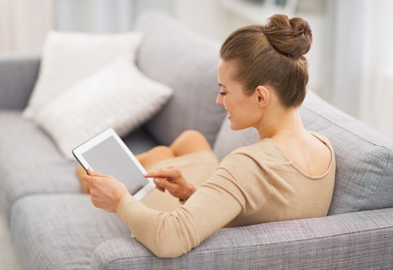 woman on sofa with ipad tablet